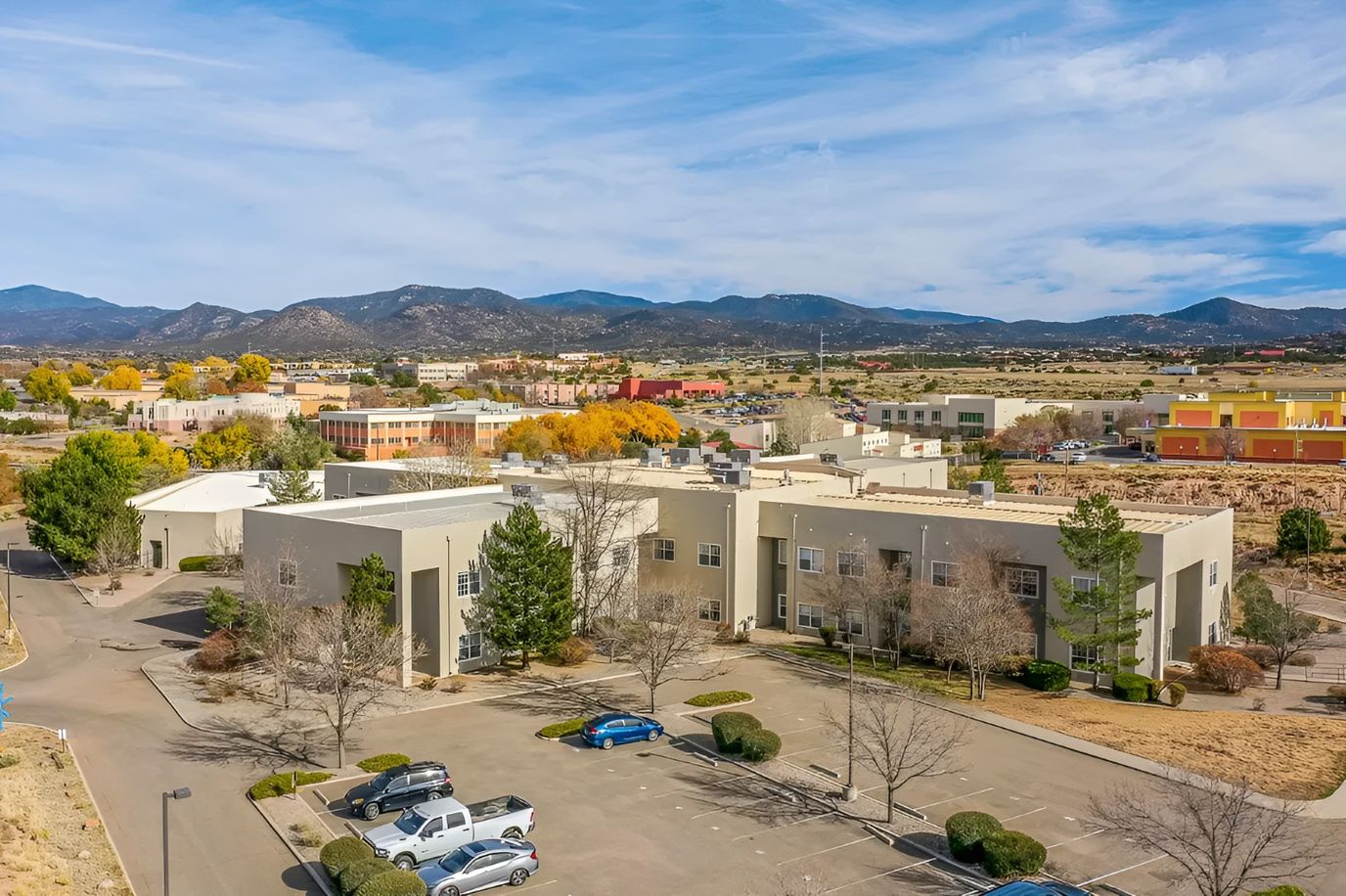 Aerial view of the Sierra Blanca Senior Living building with mountains in background