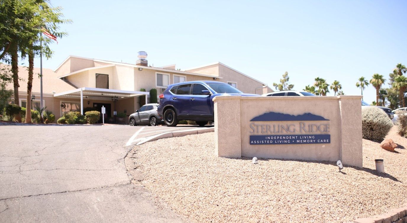 Exterior view of Sterling Ridge facility with sign and cars