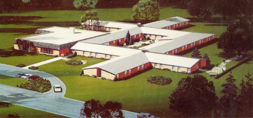 Aerial view of a senior living facility surrounded by landscaping