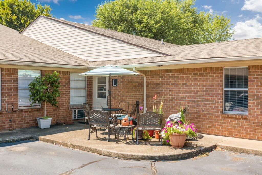 Outdoor seating area with flowers and umbrella