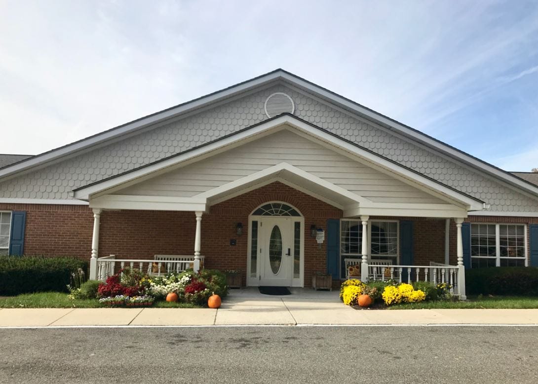 Exterior view of a senior living facility with flowers
