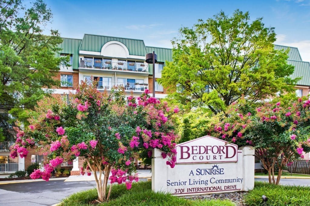 Exterior view of Bedford Court with blooming flowers