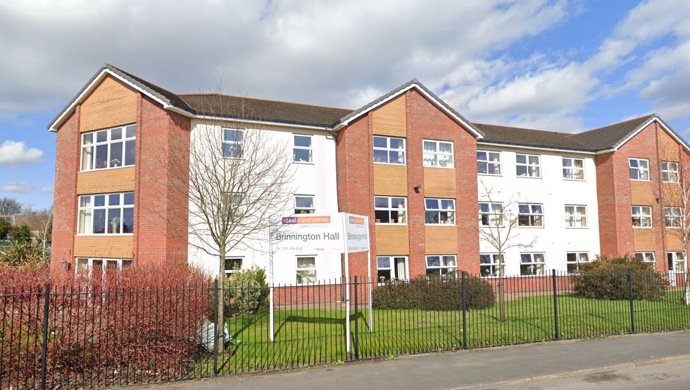 Exterior view of a senior living facility with gardens