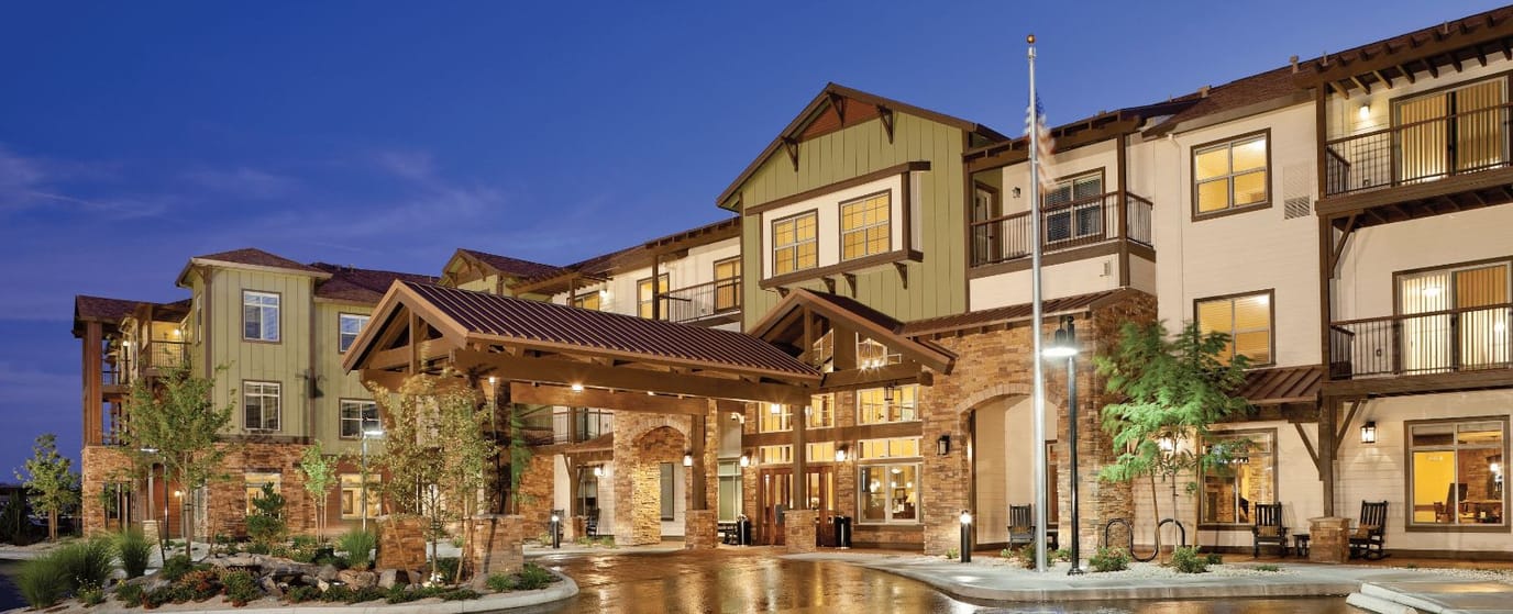 Exterior view of a senior living facility at dusk