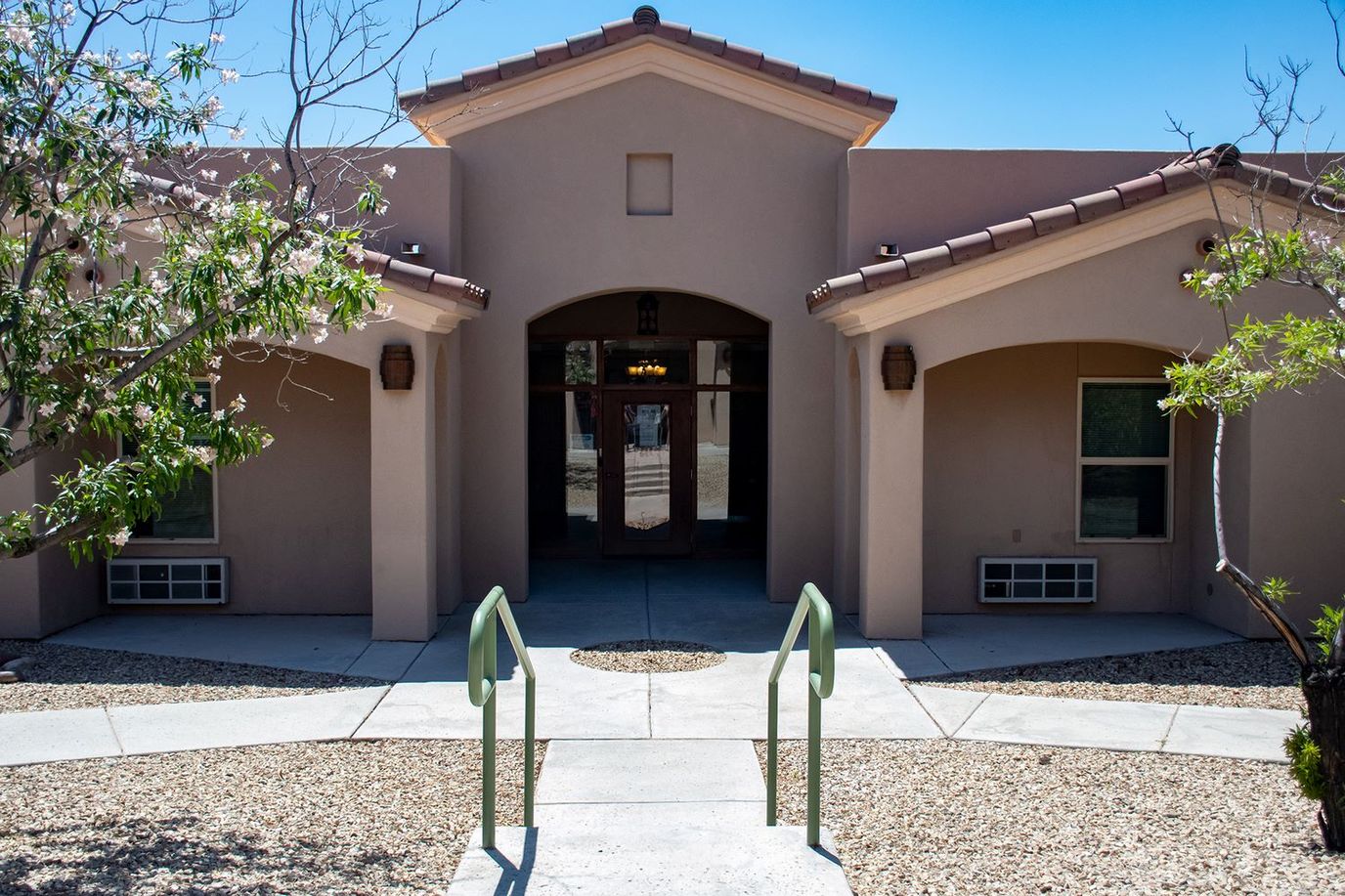 Front entrance of a facility with pathway and landscaping