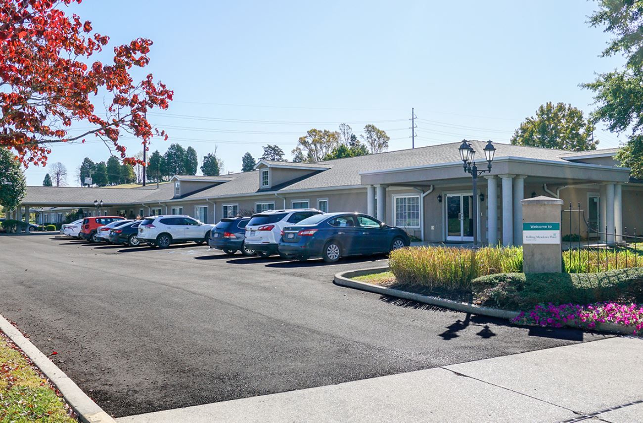 Exterior view of Paramount Senior Living with parking area