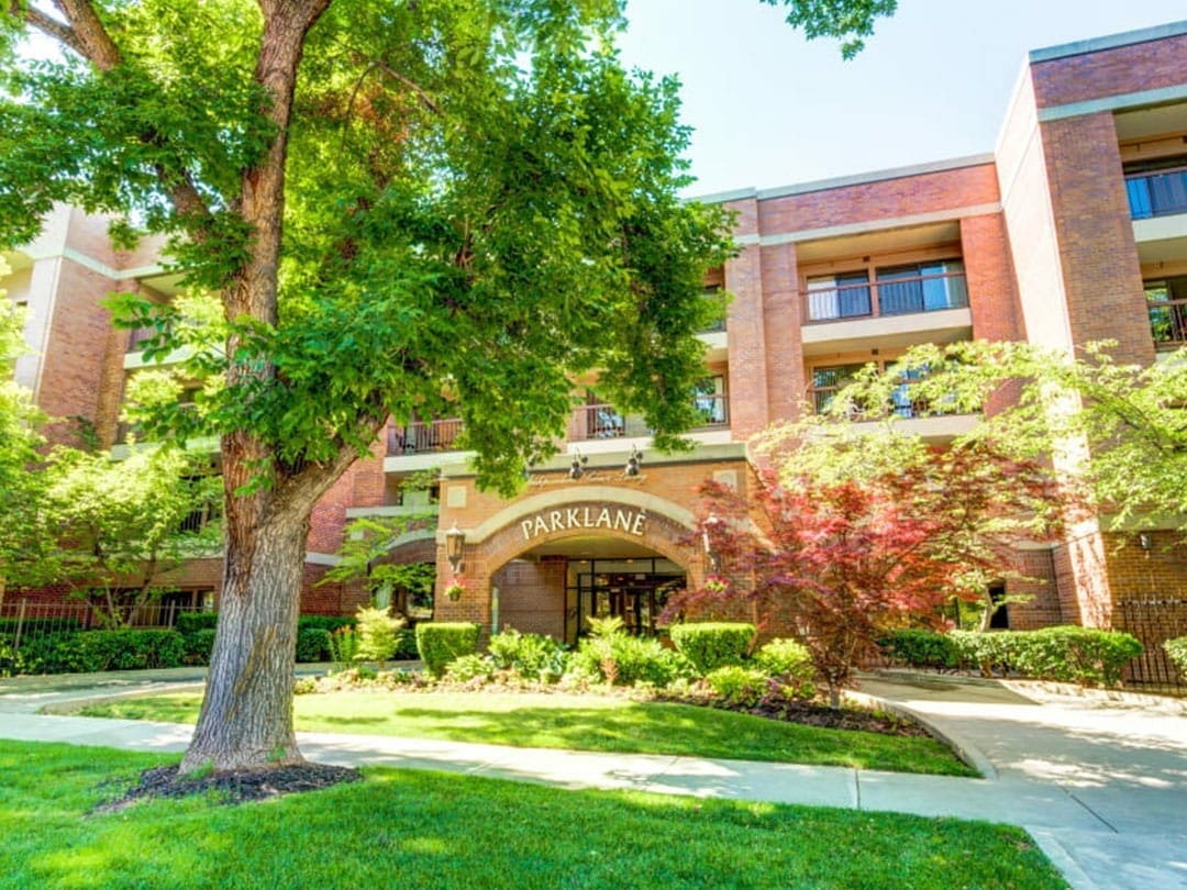 Exterior view of Park Lane Senior Living entrance with landscaping
