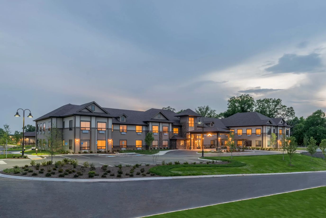 Exterior view of a senior living facility at dusk