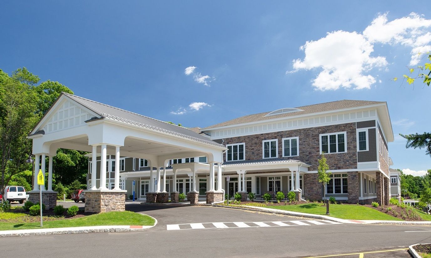 Exterior view of a senior living facility under blue skies