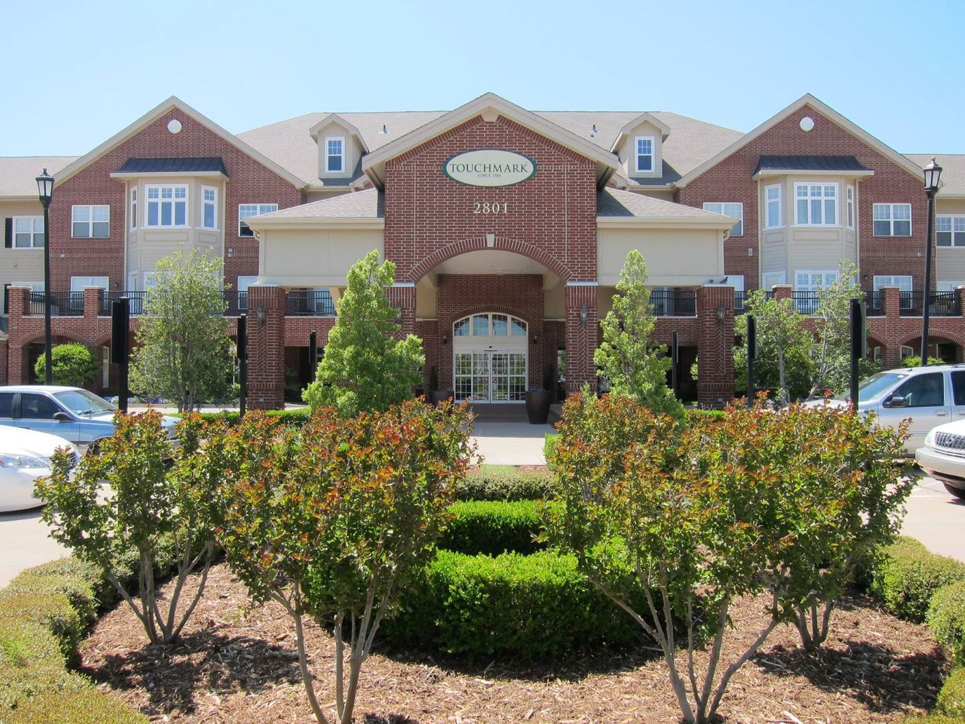 Exterior view of Touchmark building with landscaped garden
