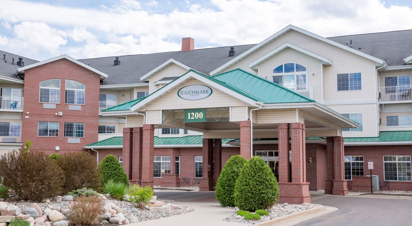Exterior view of Touchmark at Harwood Groves entryway