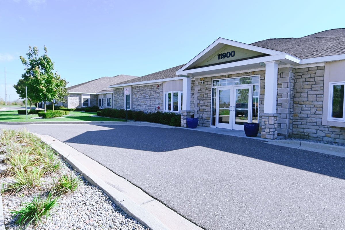 Front entrance of a senior living facility with landscaping