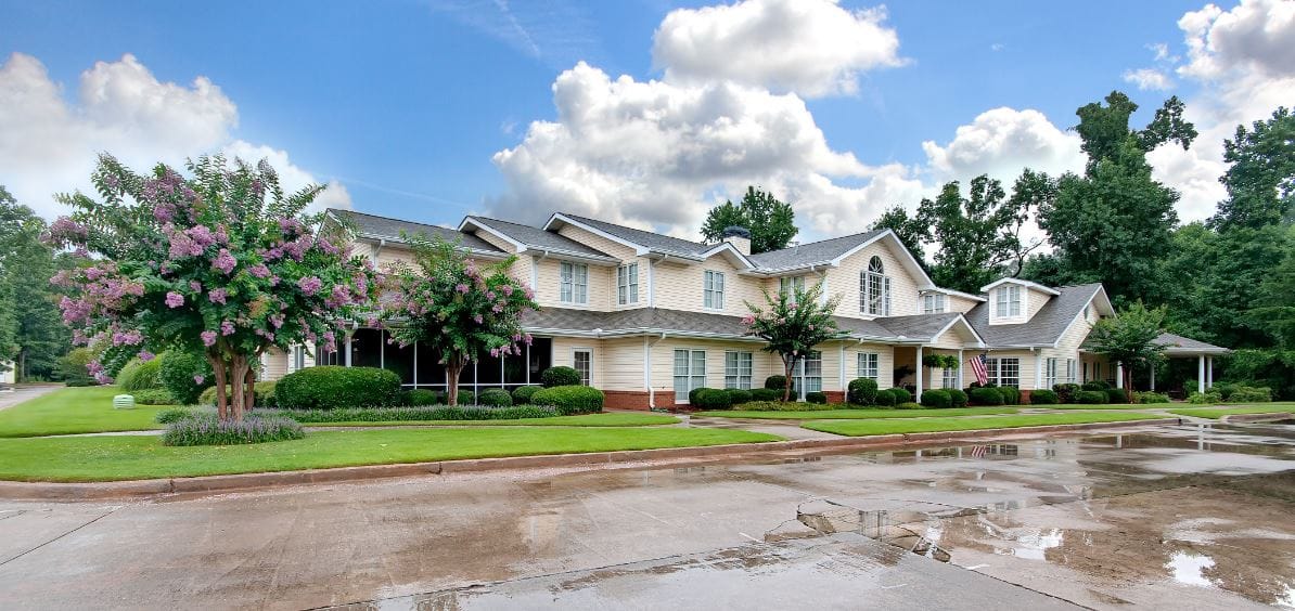 Exterior view of a senior living facility surrounded by greenery