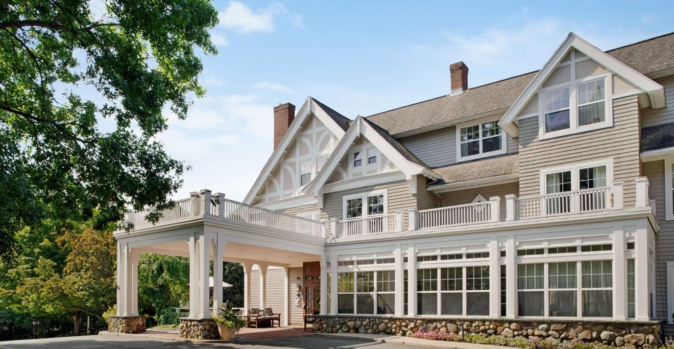 Exterior view of a senior living facility with a covered entrance