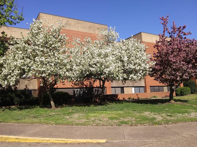 Exterior view of a nursing home with flowering trees