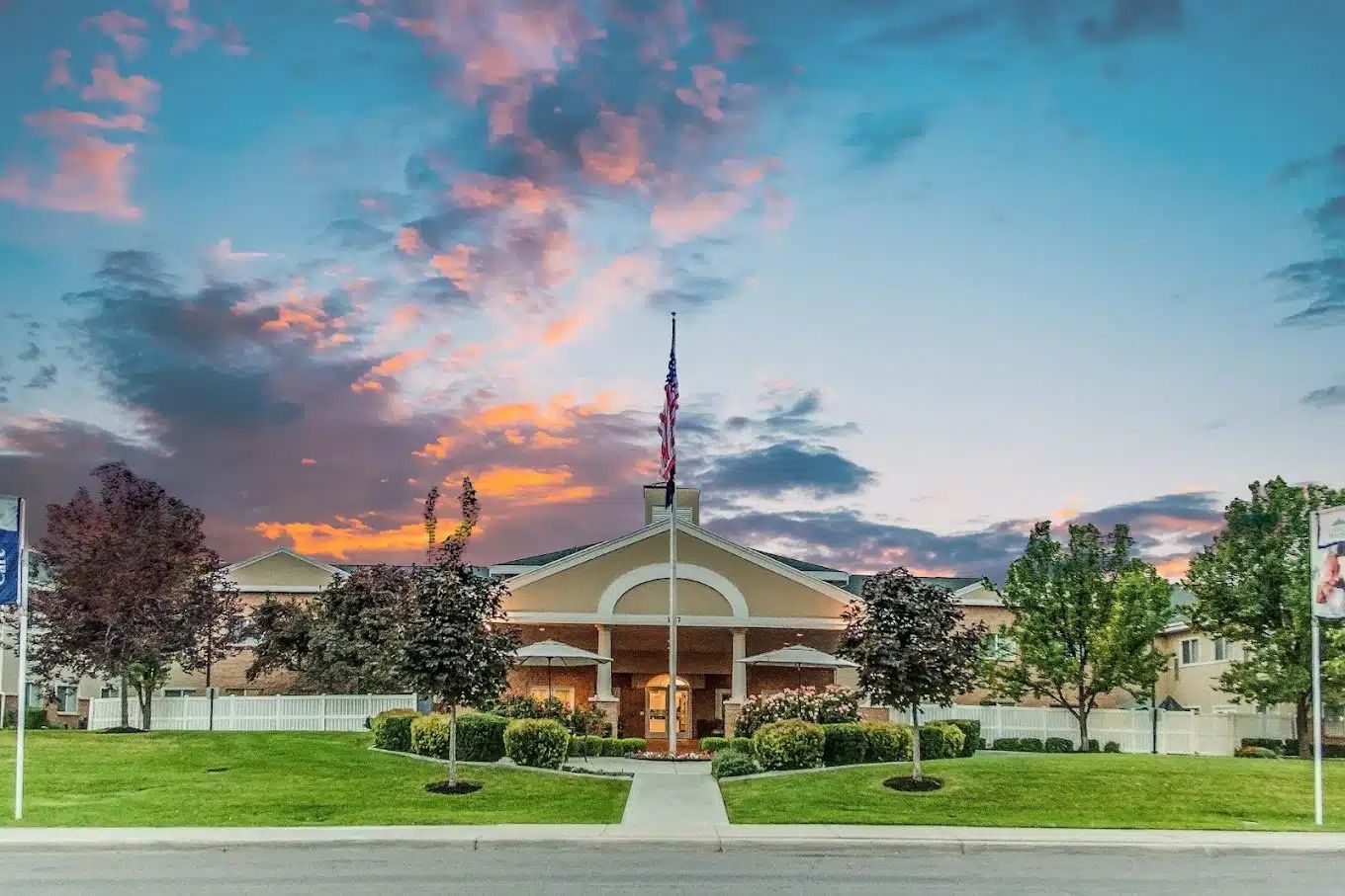 Exterior view of assisted living facility at sunset