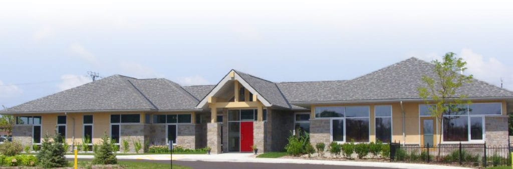 Exterior view of a senior care facility with landscaping