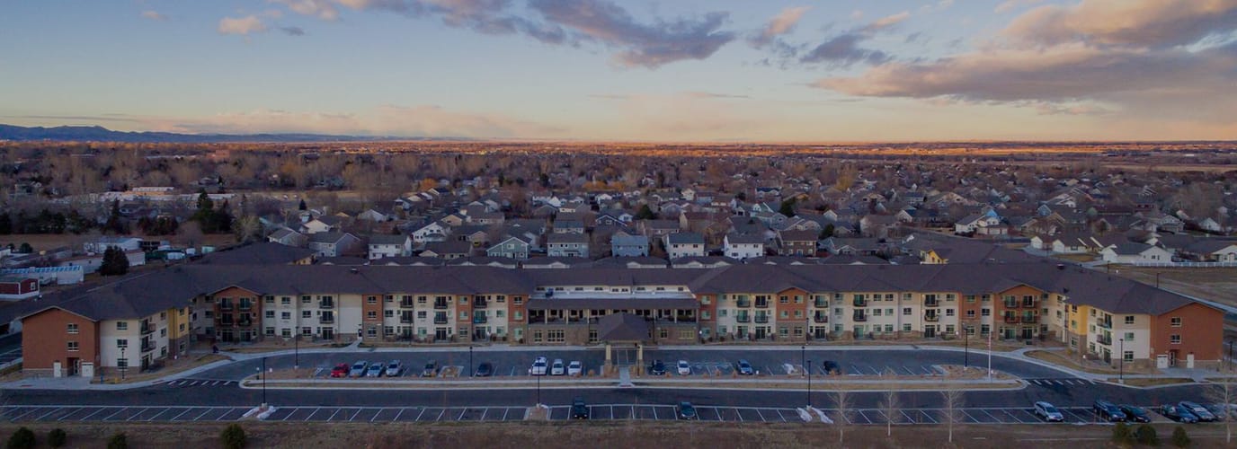 Aerial view of a senior living facility with parking