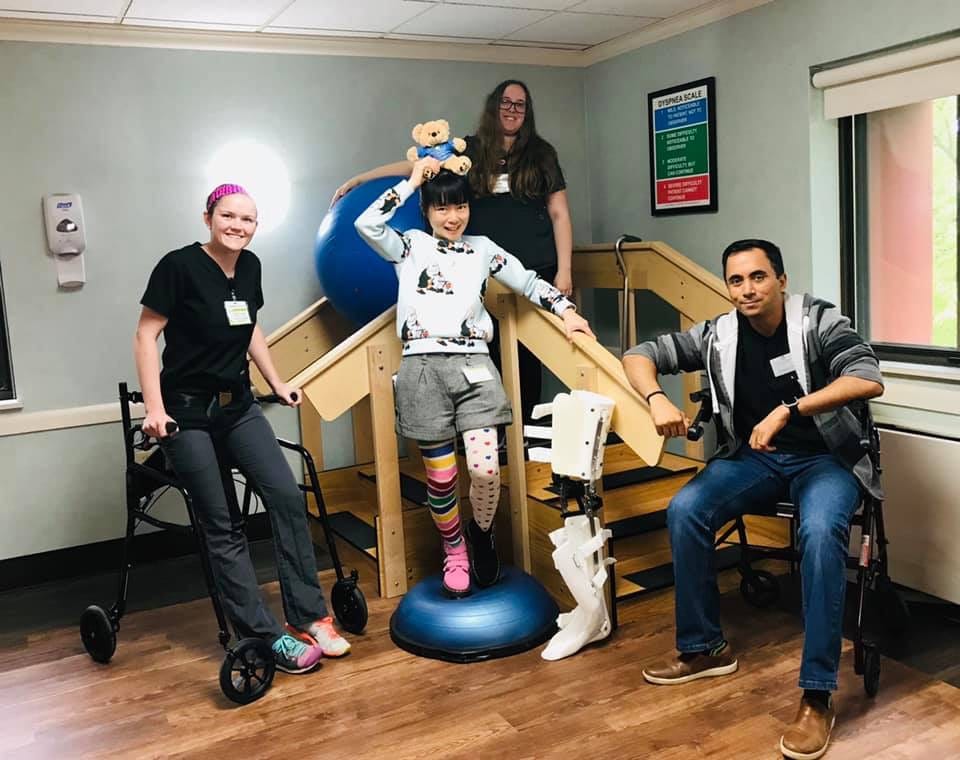 Staff assisting a resident with rehabilitation activities