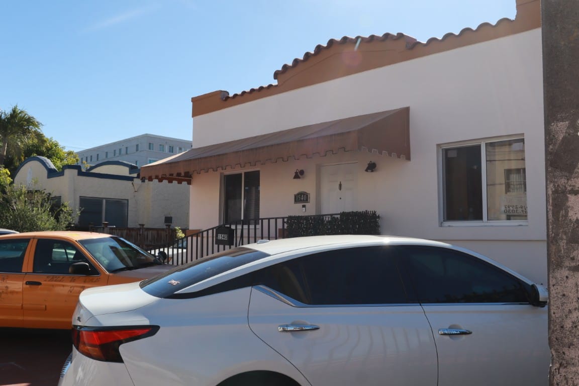 Exterior view of El Paraiso Home with parked vehicles