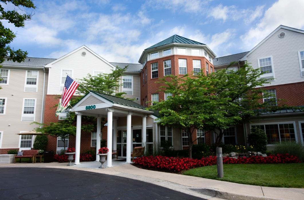 Exterior view of Morningside House with flower beds and flag