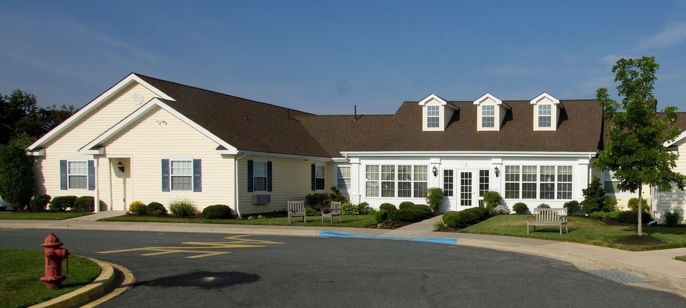 Exterior view of a senior living facility with gardens
