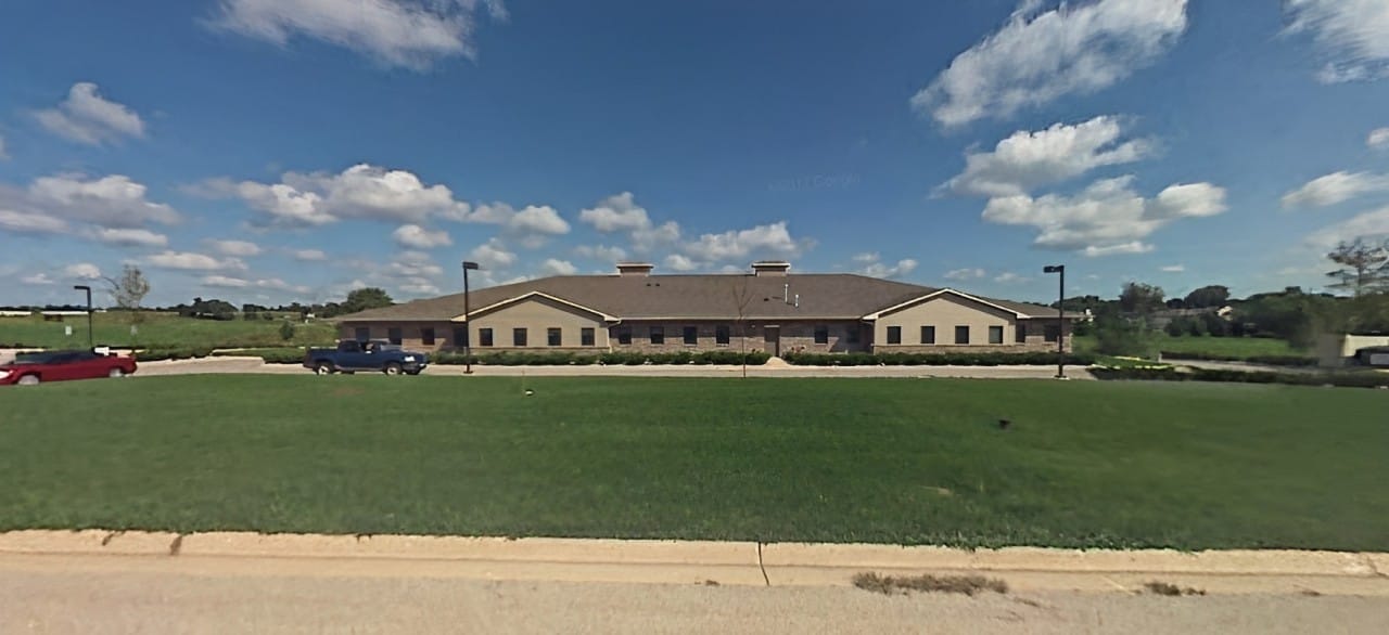 Exterior view of Anam Care facility with spacious lawn
