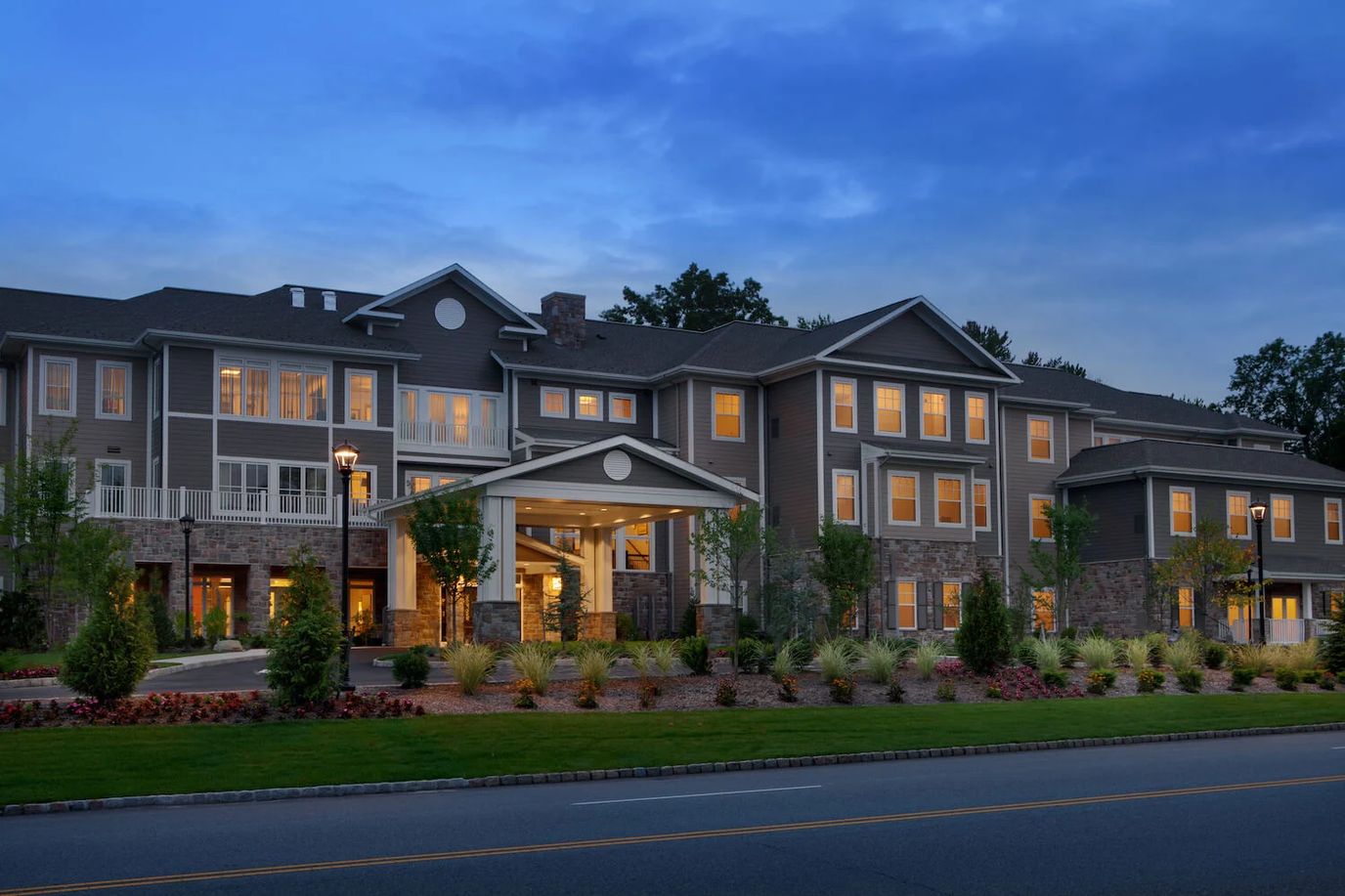 Exterior view of a senior living facility at dusk
