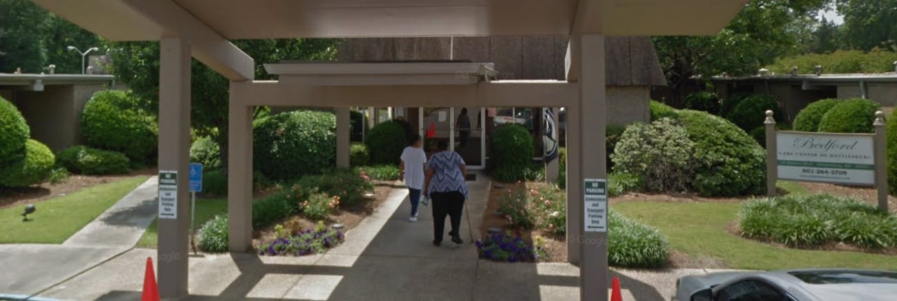 Residents entering the facility under portico