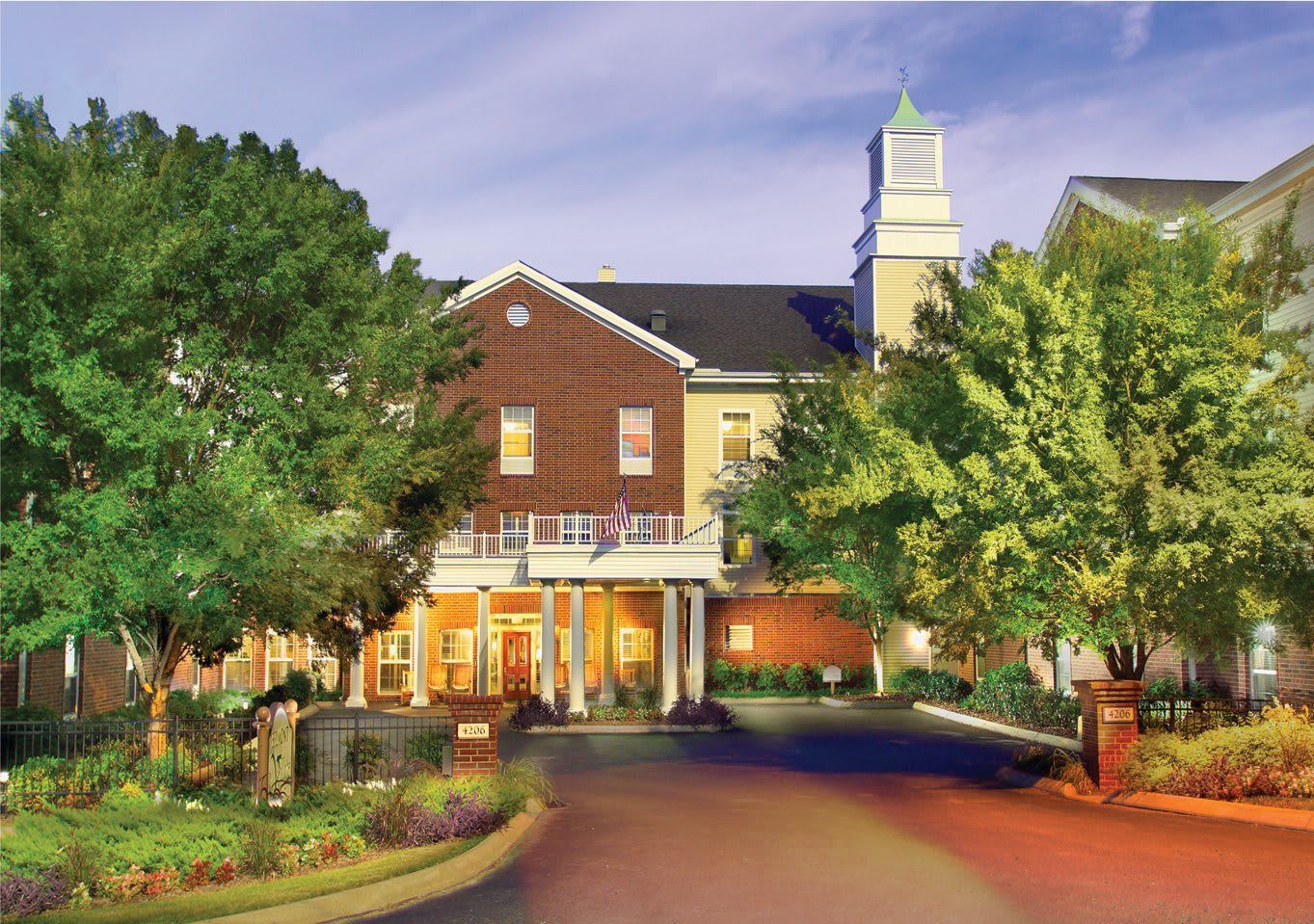 Front entrance of the assisted living facility surrounded by trees
