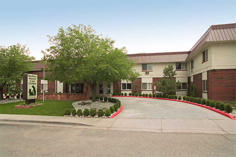 Exterior view of assisted living facility with landscaped entrance