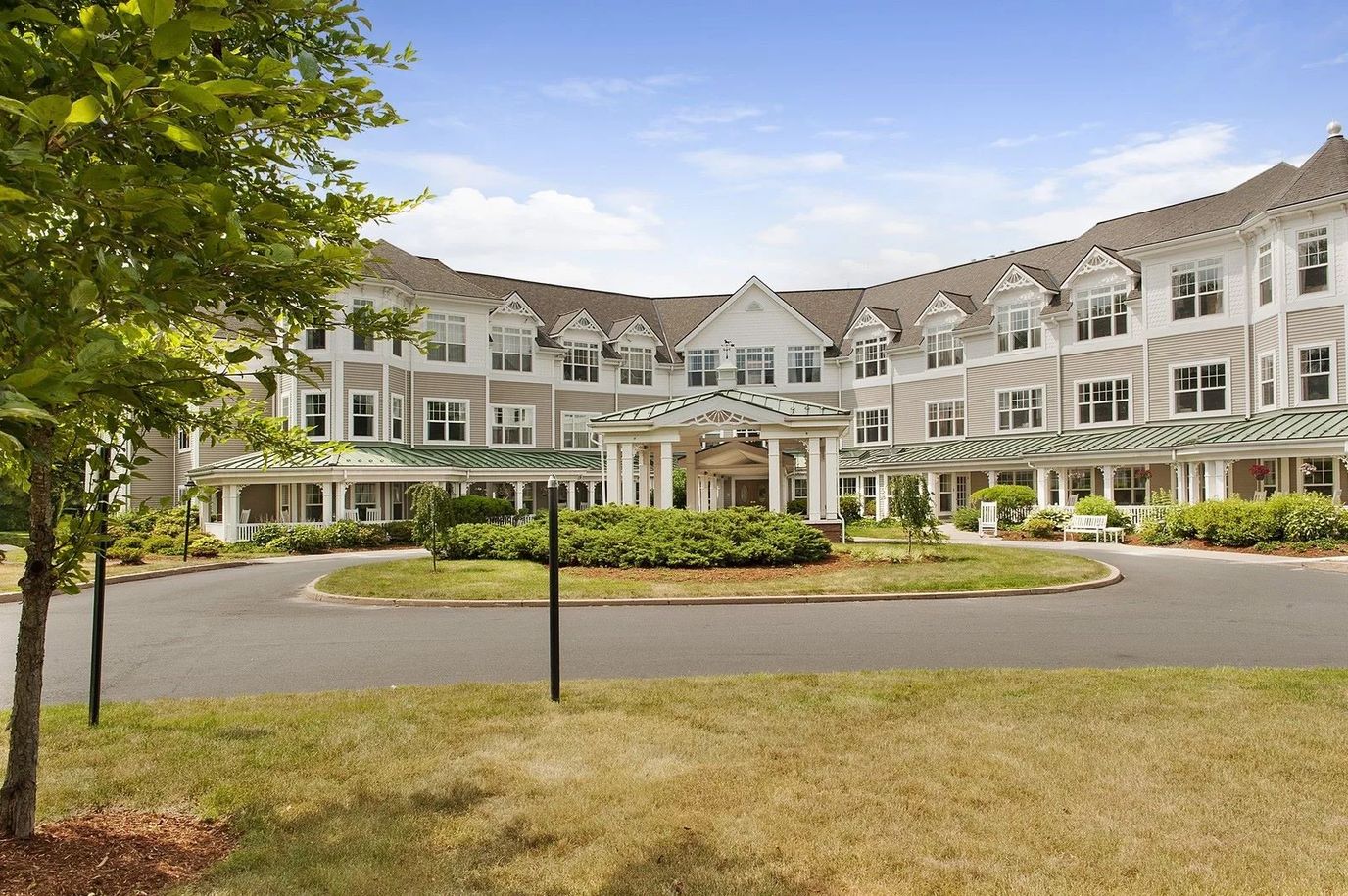 Exterior view of a senior living facility with gardens