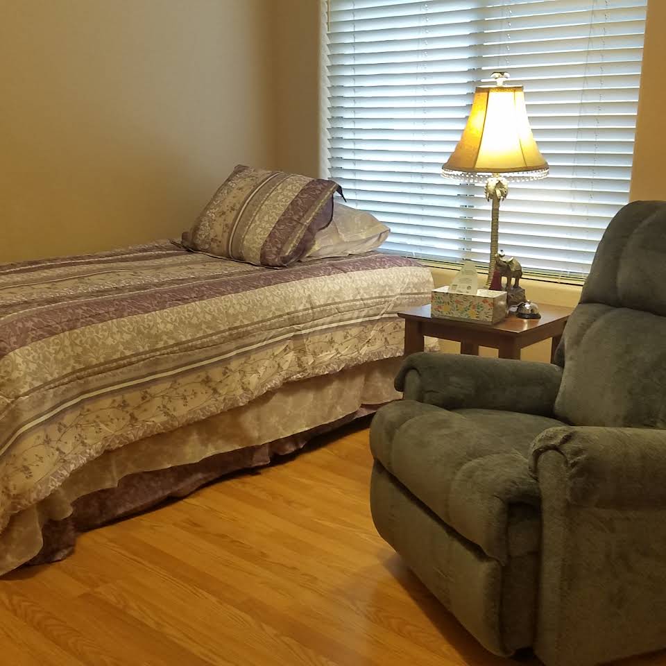 Cozy bedroom setup with a bed and recliner