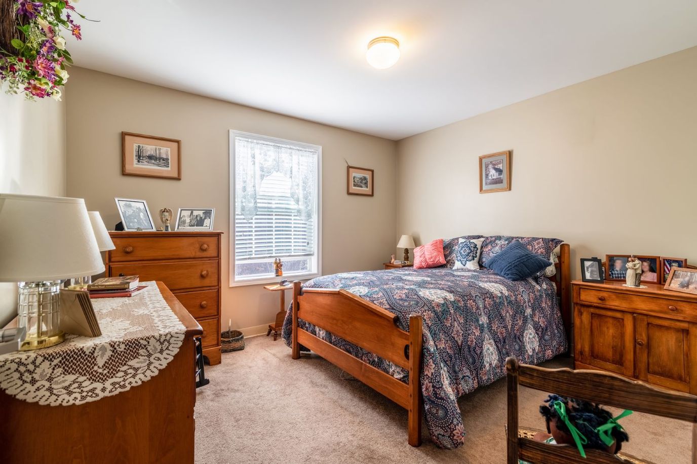 Connect55+ Concord, assisted living in Concord, NH — Cozy bedroom with wooden furniture and decorative accents