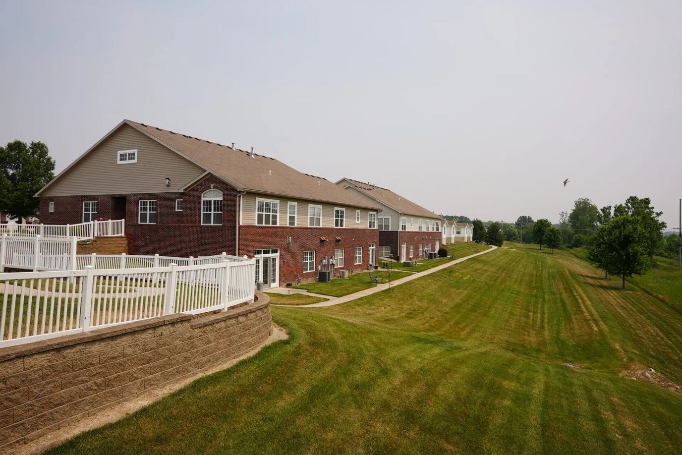Exterior view of assisted living building with landscaped grounds