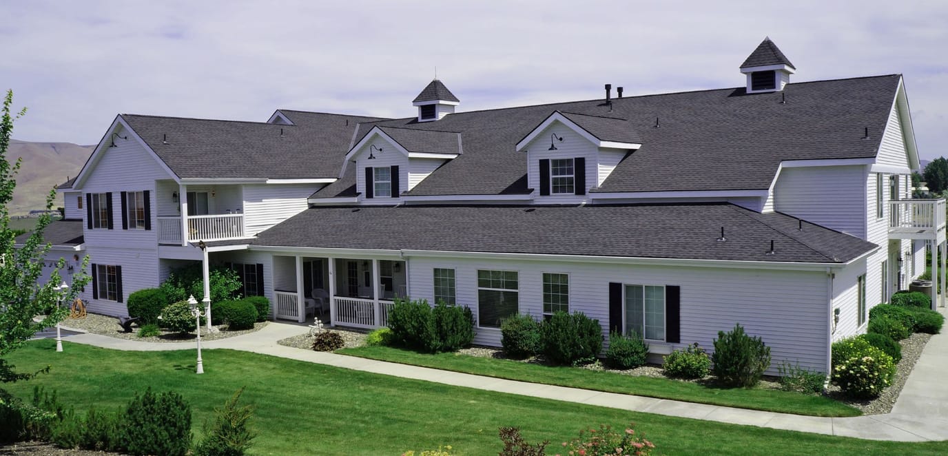 Exterior view of the assisted living facility with landscaped grounds