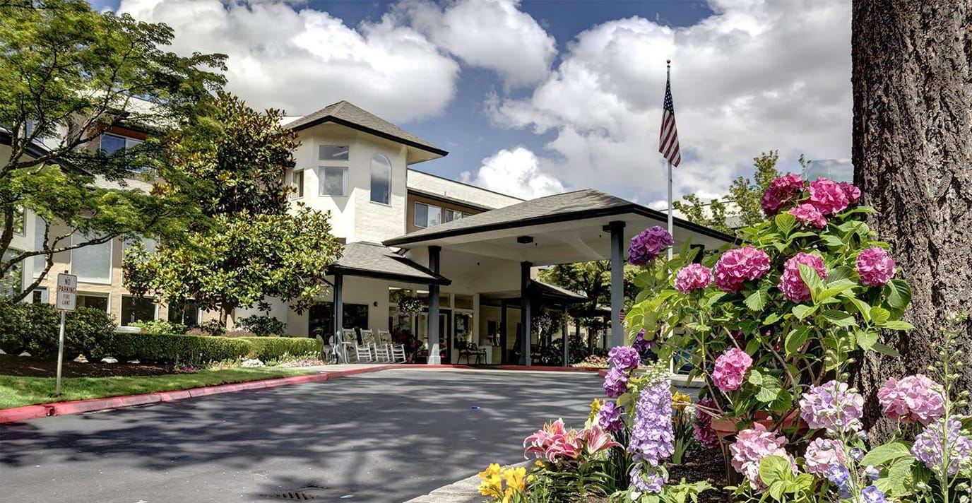 Exterior view of Solista Bellevue with flowers and trees