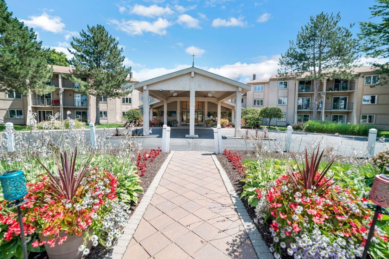Entrance to Holiday Winter Village with flower beds and landscaping