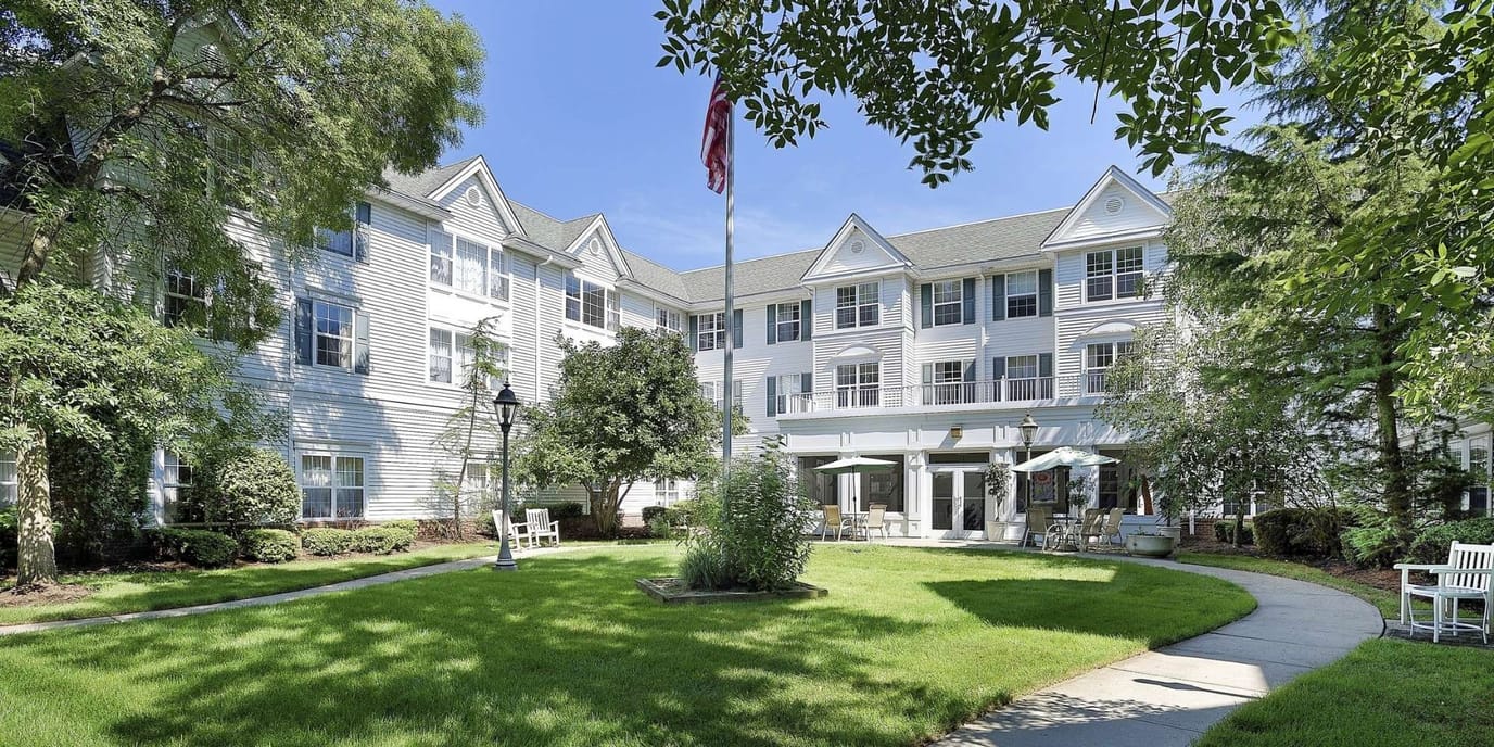 Exterior view of a senior living facility with landscaped garden