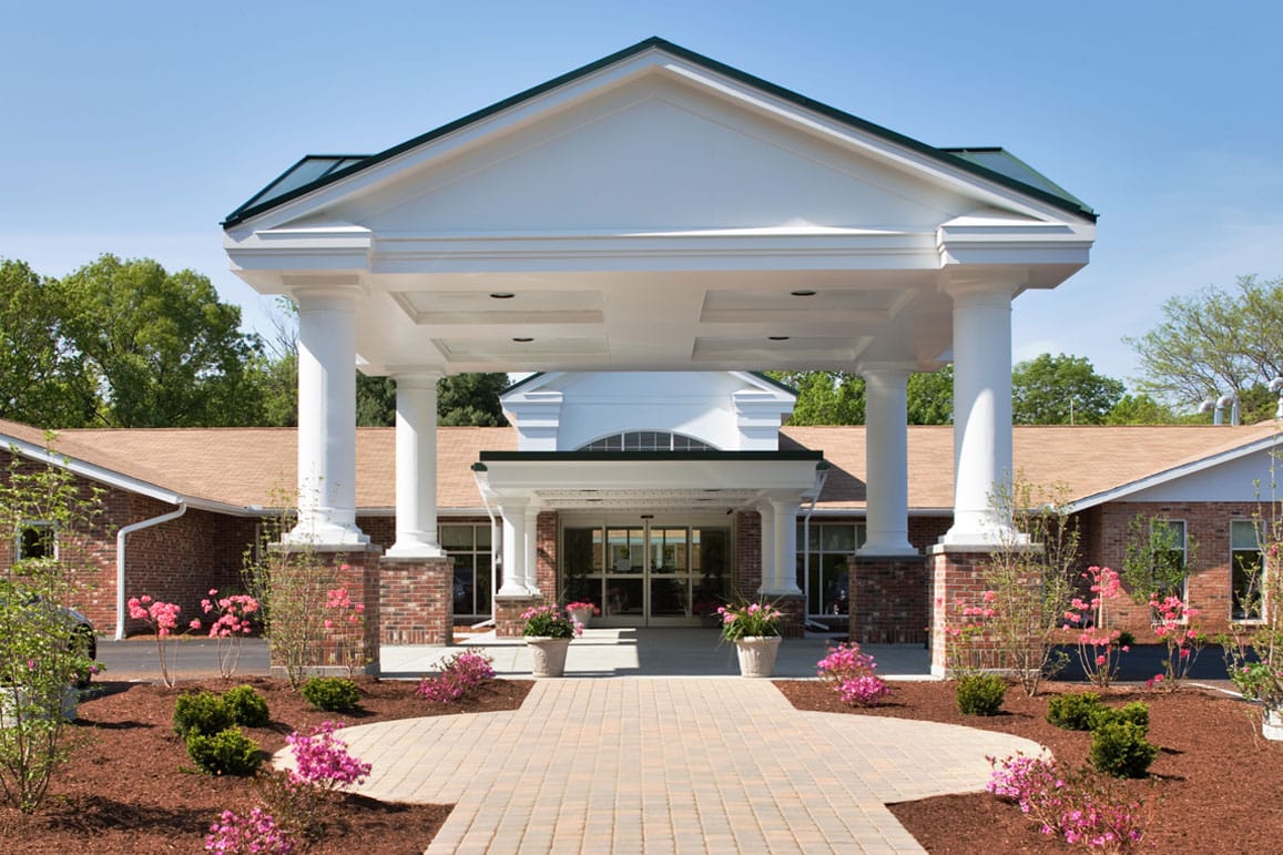 Facade of the Kent Regency Center with blooming flowers