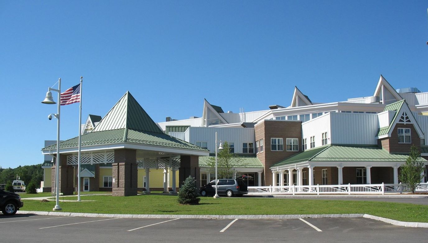 Exterior view of the nursing home with flag and entrance