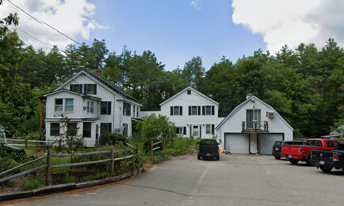 Exterior view of a multi-building facility with parking lot