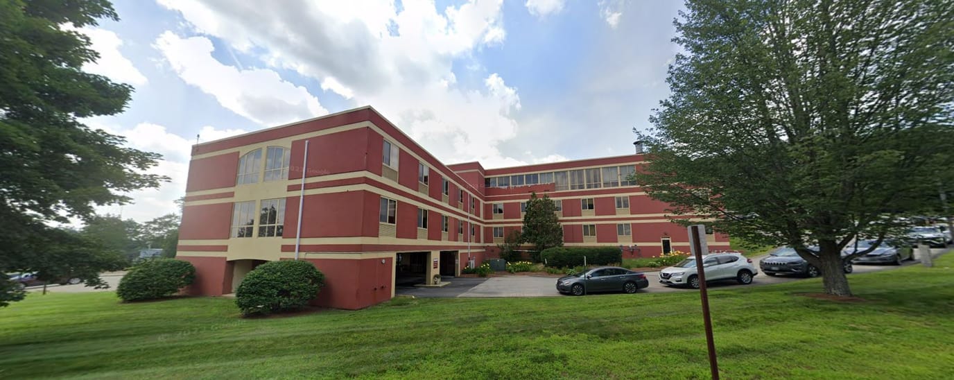 Exterior view of a senior living facility surrounded by landscaping