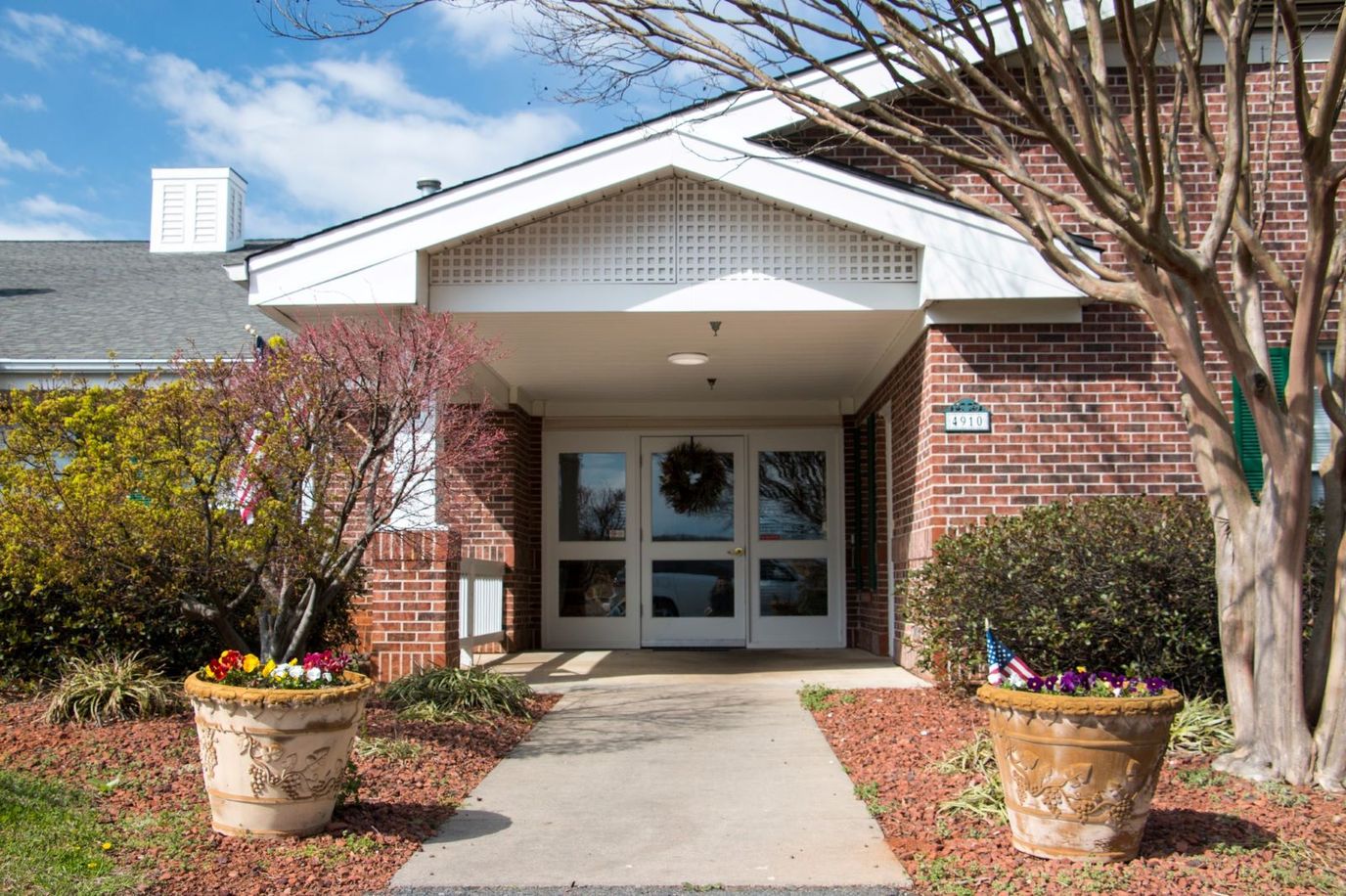 Entrance of Preston House with flower pots and landscaping