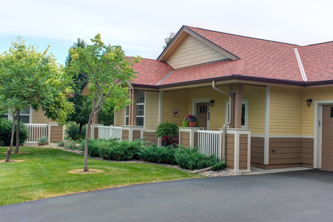 Exterior view of a senior living building with landscaping