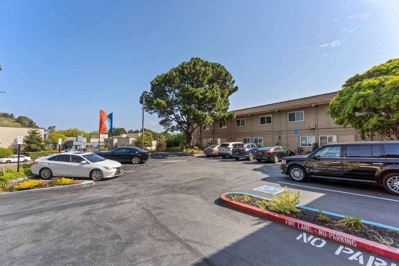 Exterior view of the facility parking area with greenery