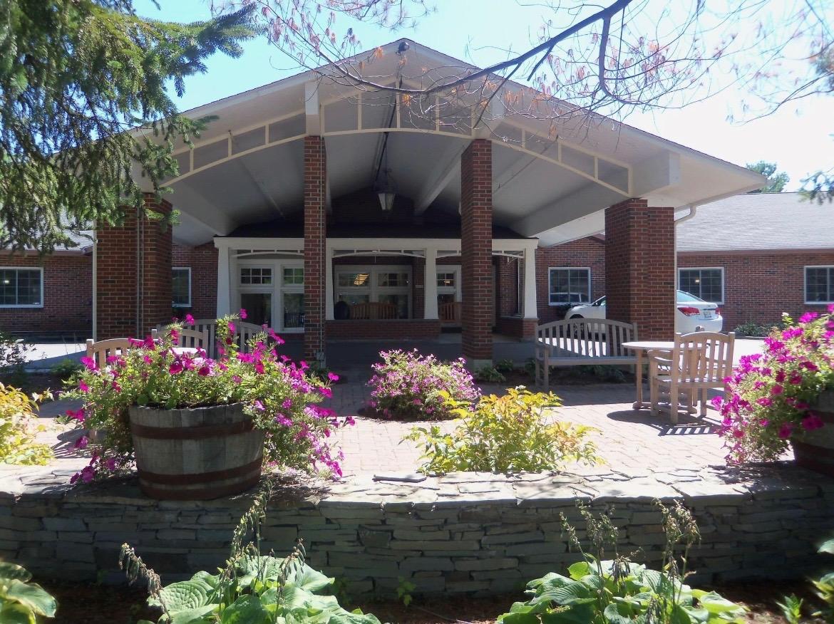 Entrance of Stillwater Health Care with flowers