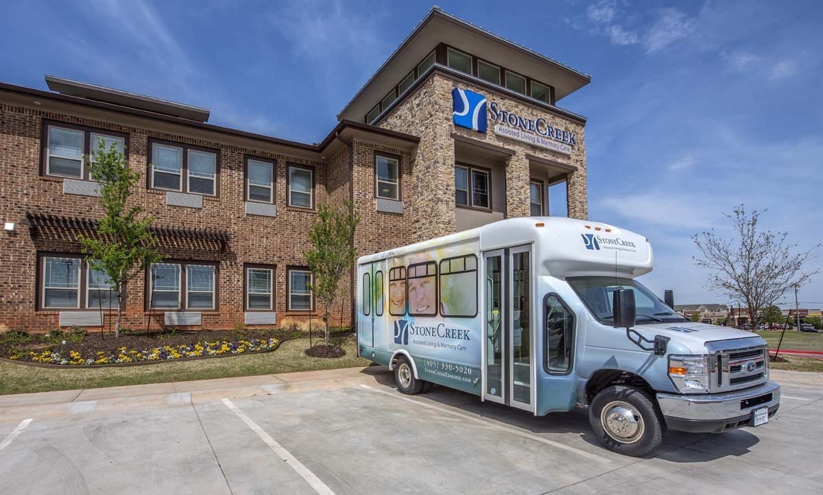 Exterior view of StoneCreek Assisted Living with shuttle bus