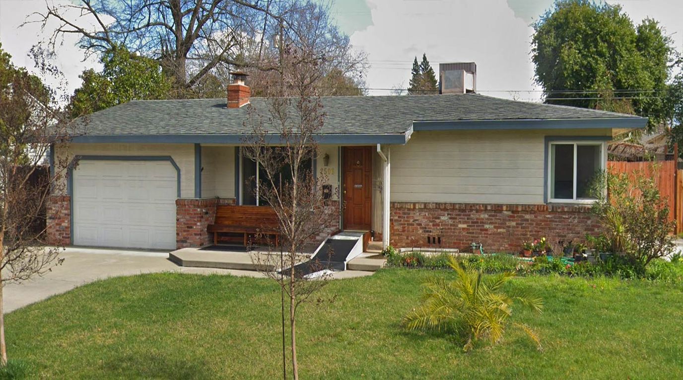 Exterior view of a single-story residential building with porch