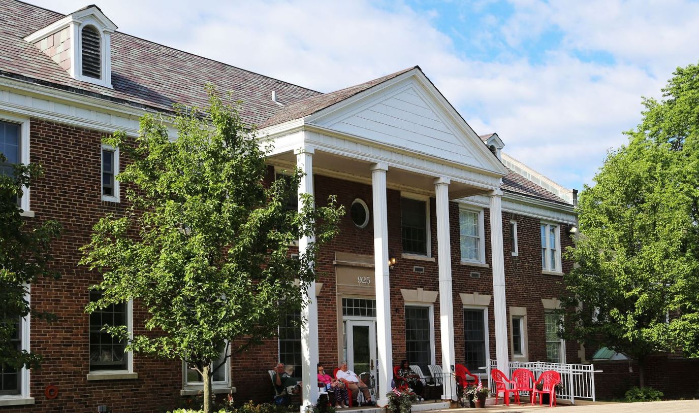Exterior view of Sunnymere with residents relaxing